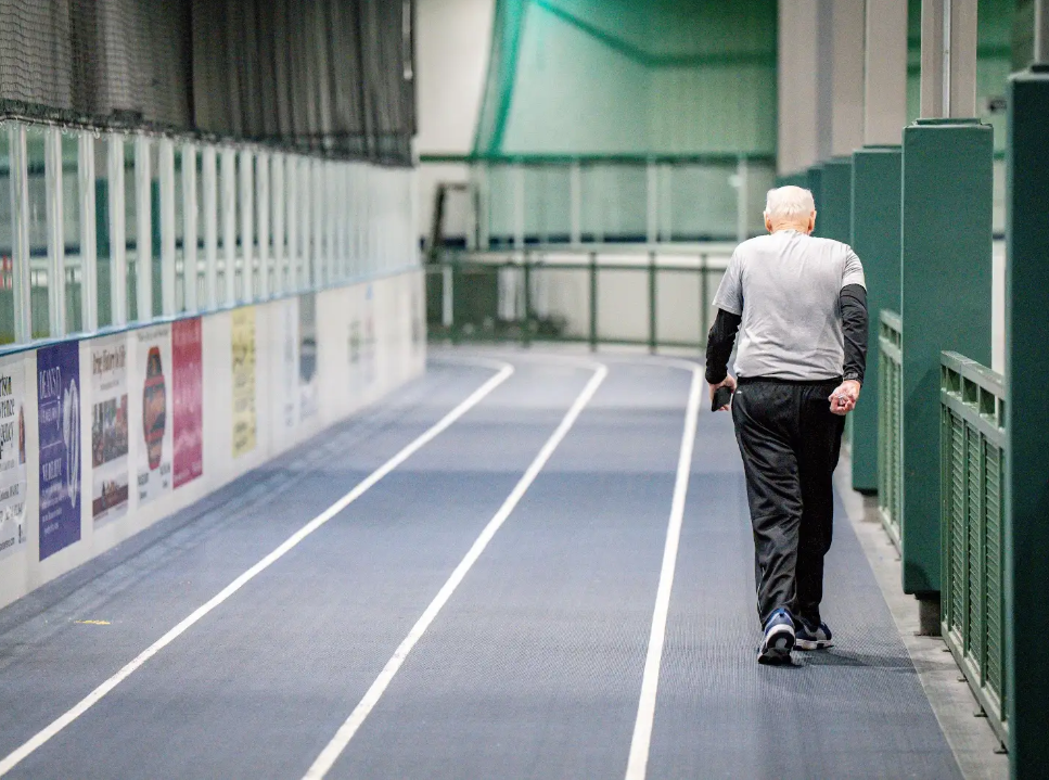 A member walking on the indoor track